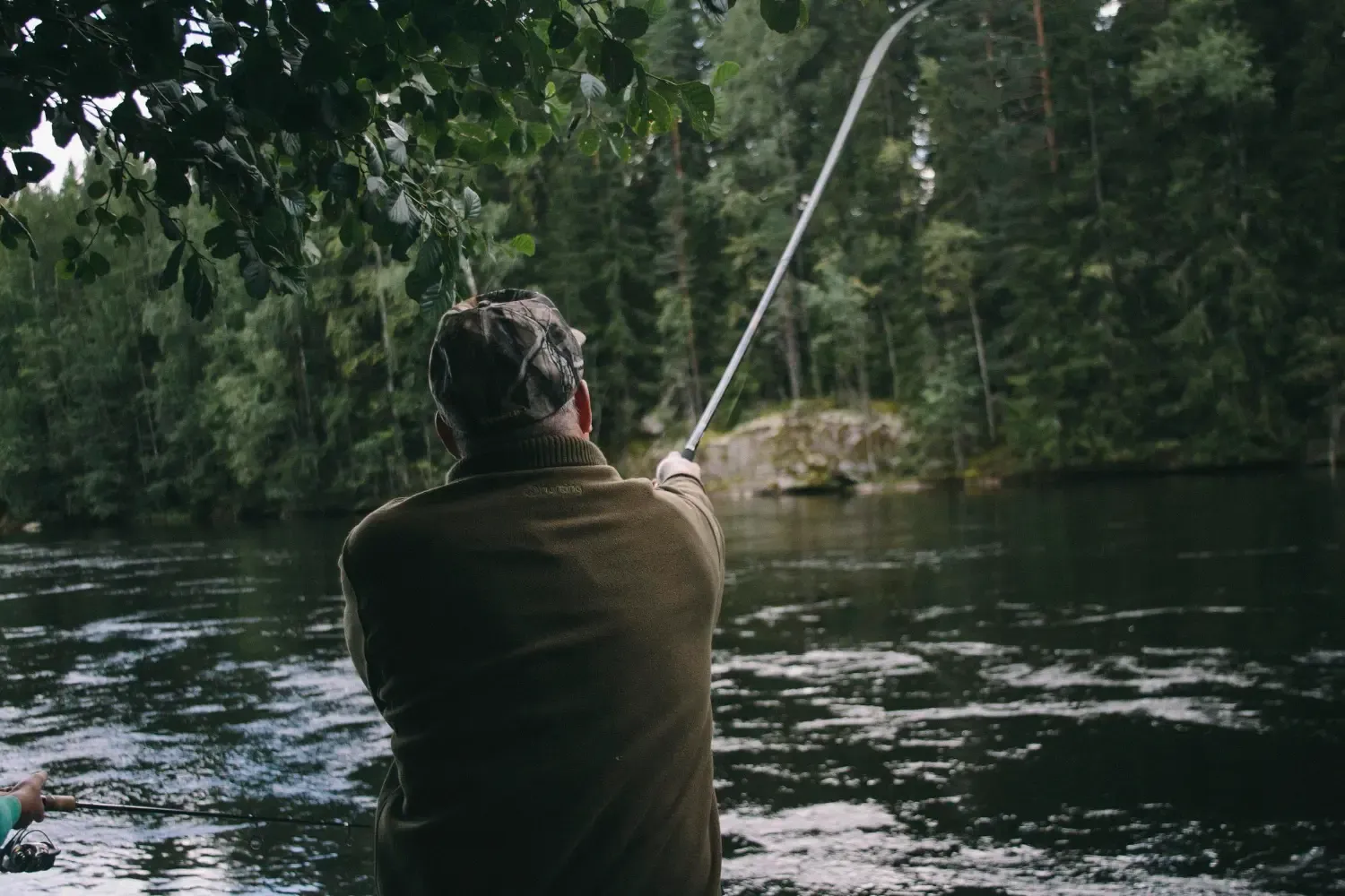 Symbolfoto Angler beim Fischen am Fluss